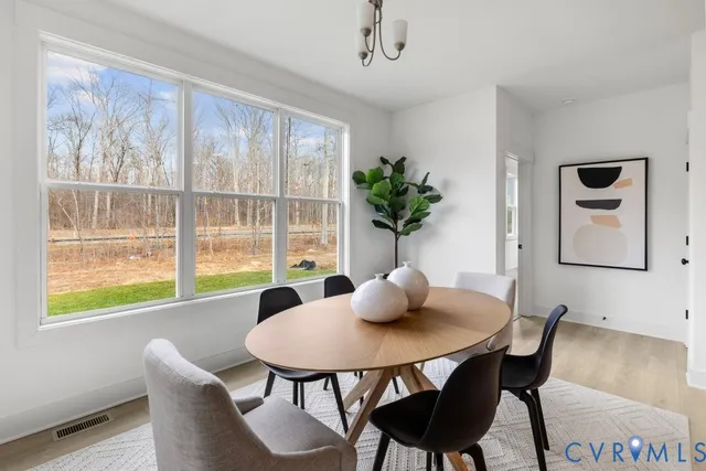 a dining room with furniture and window