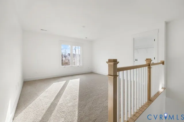 a spacious bedroom with a bed and a window