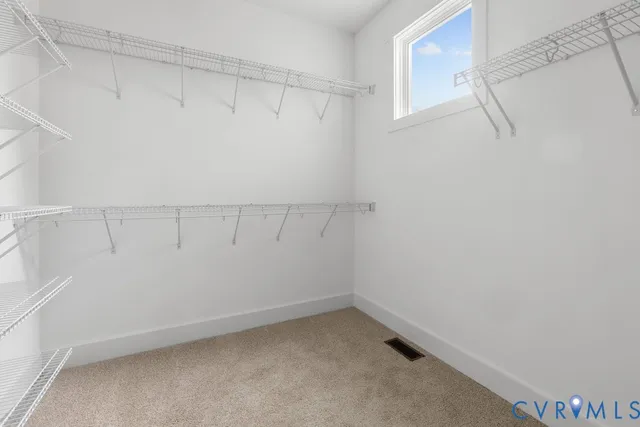 a bedroom with two beds and painting on the wall