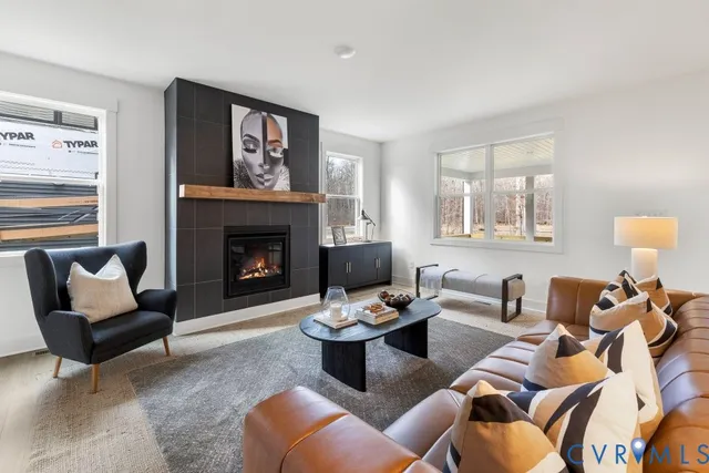 a living room with furniture and a fireplace