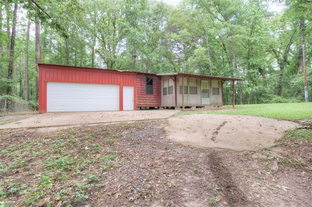 1267 Johnson Road Doyline, LA 71023 - Photo 2 of 19 a front view of a house with a yard and garage