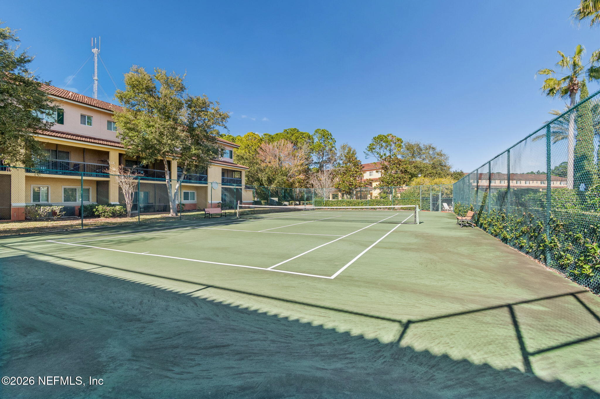 9745 Touchton Road, Unit 2903 Jacksonville, FL 32246 - Photo 117 of 155 a view of a tennis ground with large trees