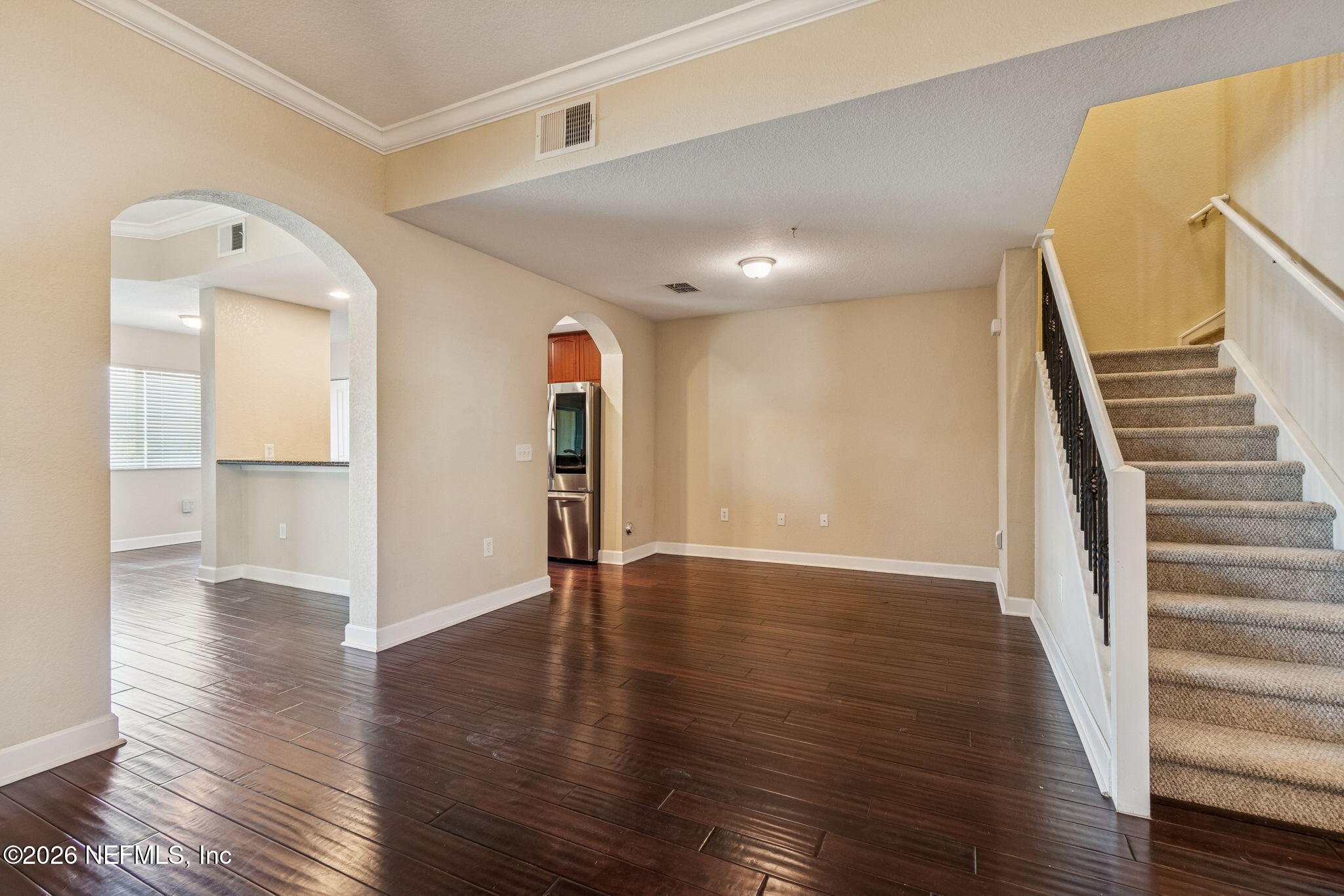 9745 Touchton Road, Unit 2903 Jacksonville, FL 32246 - Photo 12 of 155 a view of an empty room with wooden floor and stairs