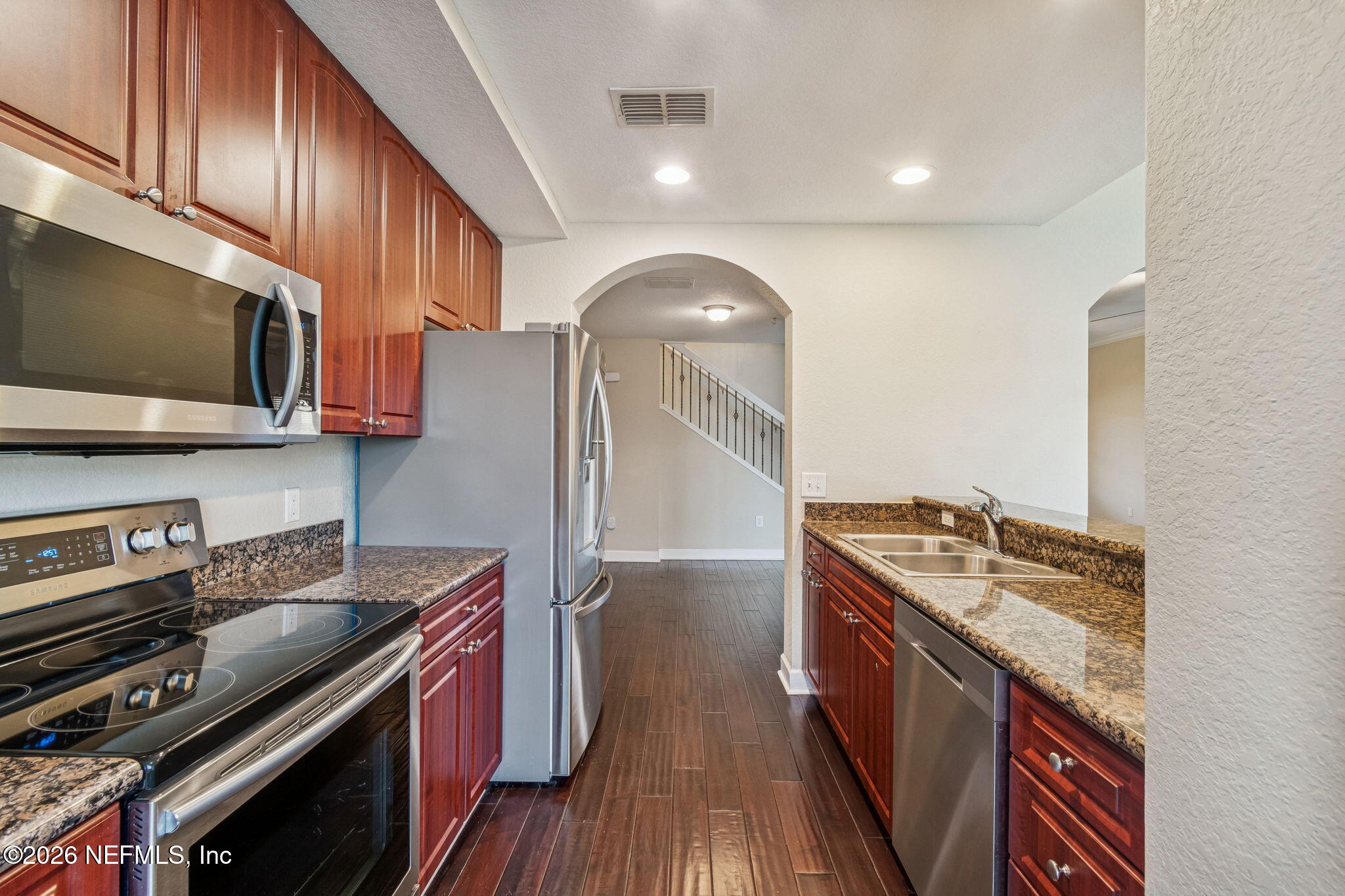 9745 Touchton Road, Unit 2903 Jacksonville, FL 32246 - Photo 20 of 155 a kitchen with stainless steel appliances granite countertop a stove a sink and a microwave