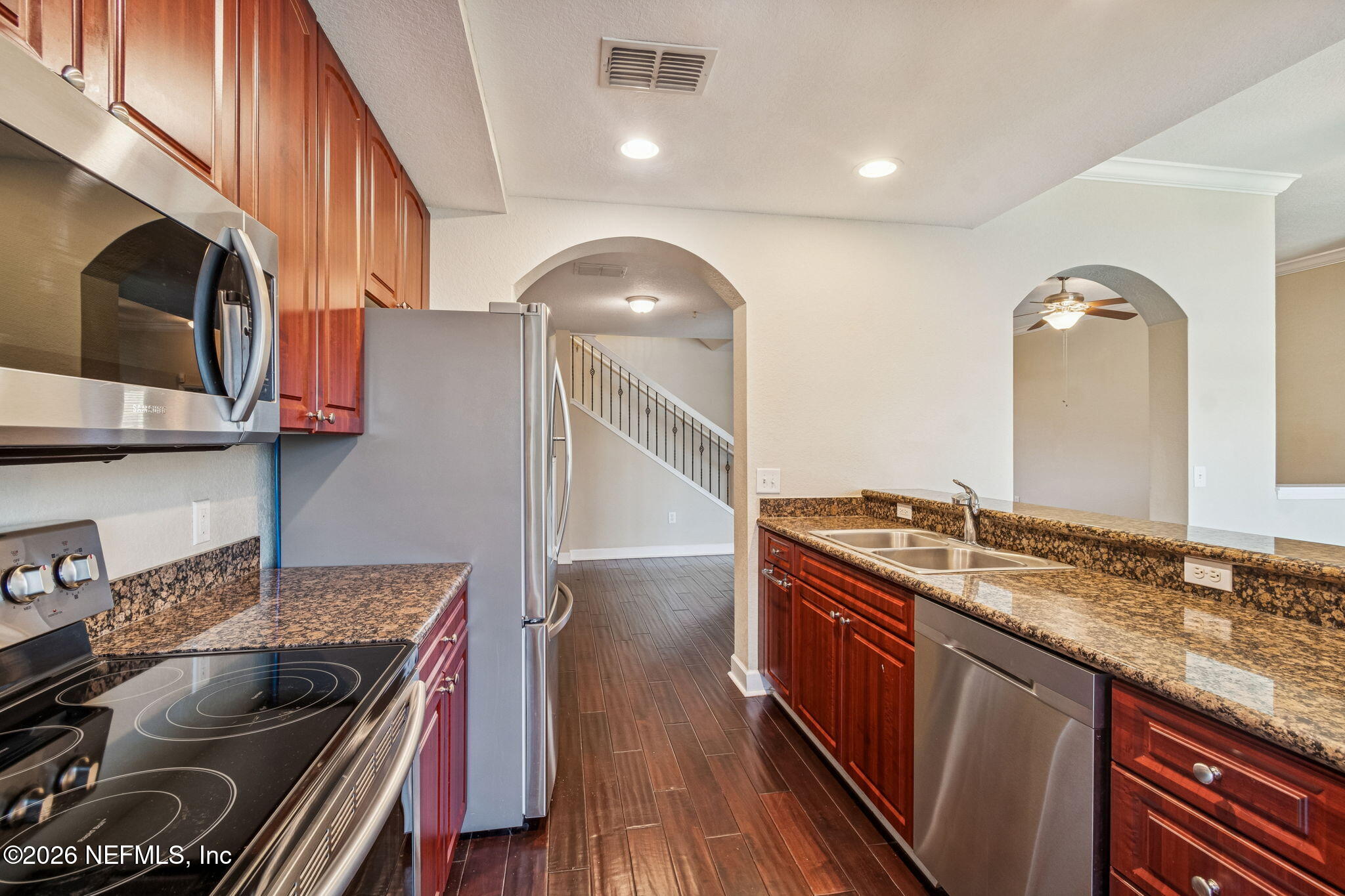 9745 Touchton Road, Unit 2903 Jacksonville, FL 32246 - Photo 21 of 155 a kitchen with granite countertop a stove and a sink