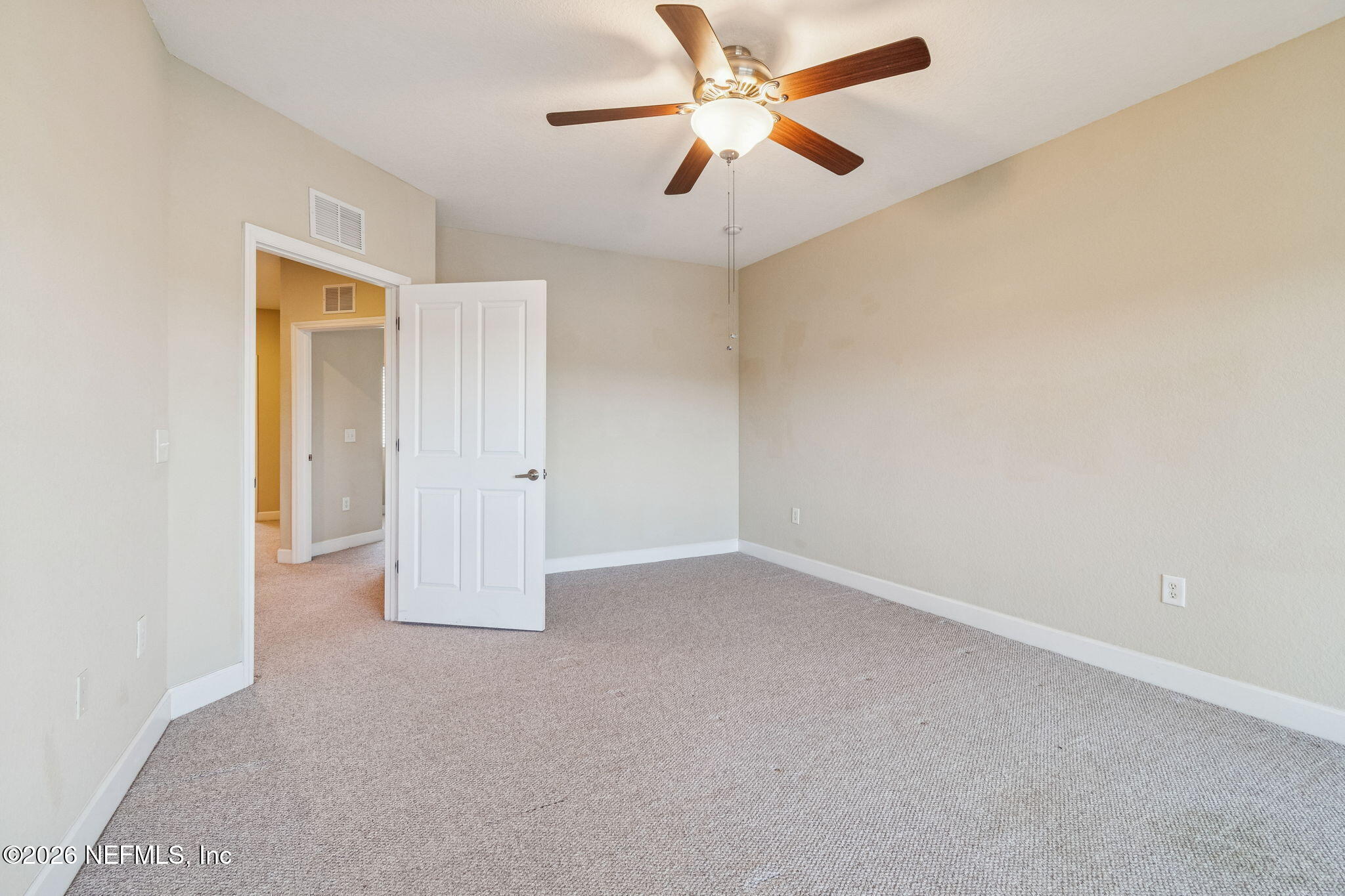9745 Touchton Road, Unit 2903 Jacksonville, FL 32246 - Photo 49 of 155 an empty room with a ceiling fan and a window