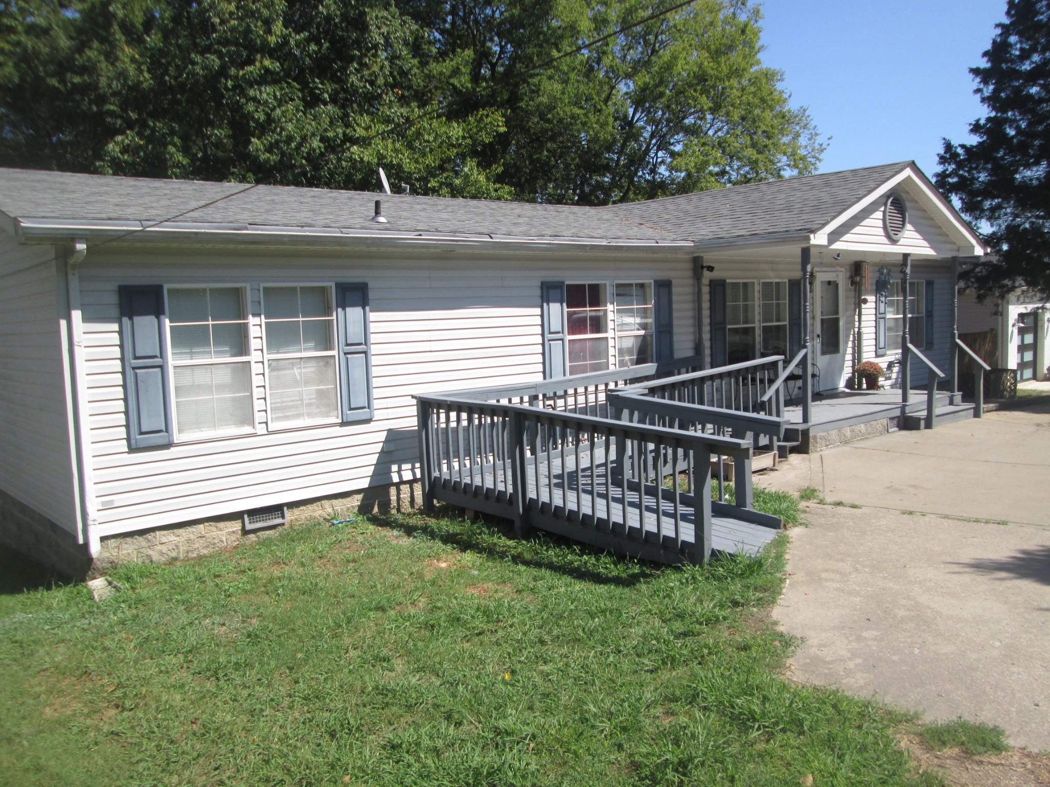 321 Manzano Road Madison, TN 37115 - Photo 1 of 16 a view of a house with a small yard and wooden deck