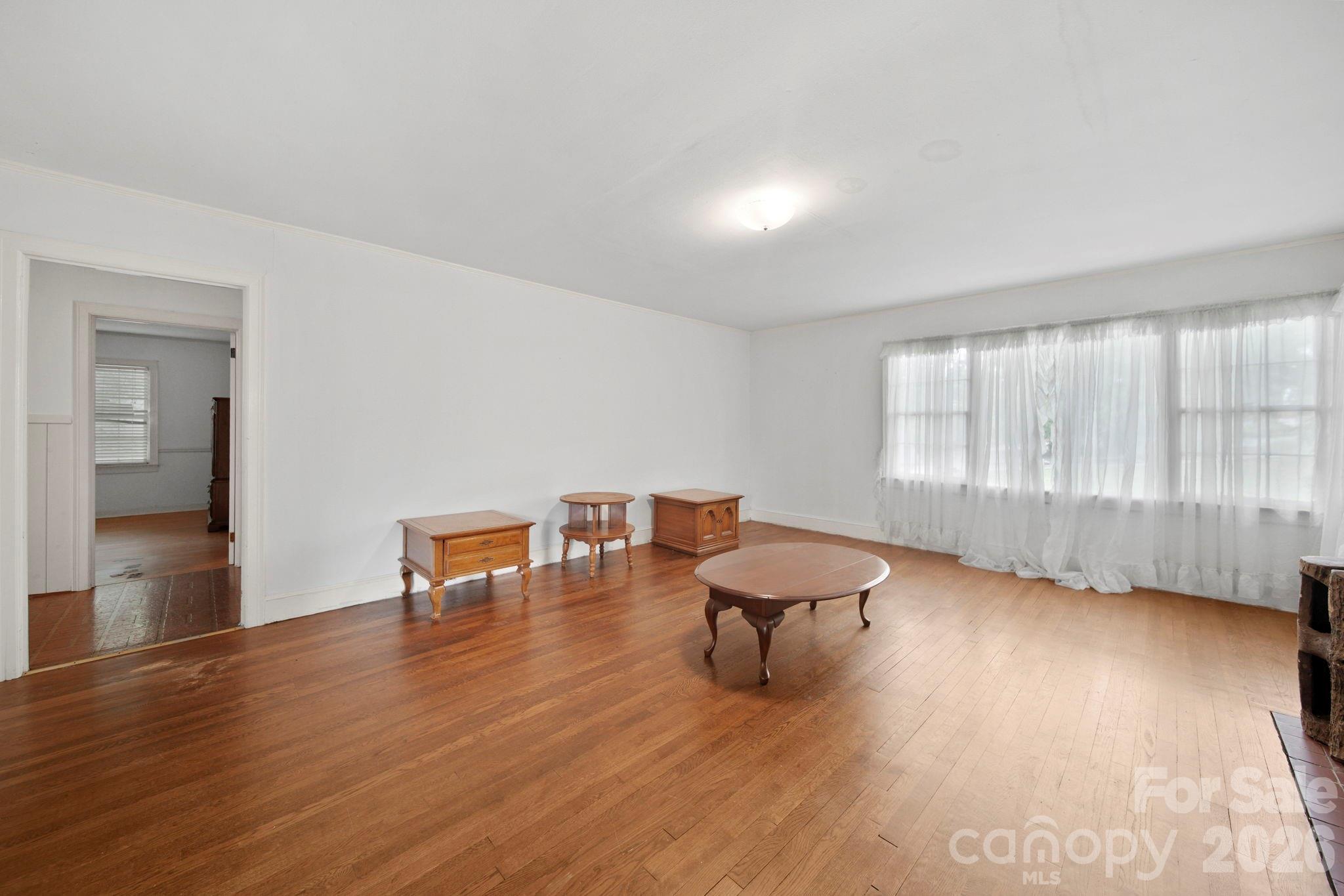 1109 Union Road Gastonia, NC 28054 - Photo 12 of 44 an empty room with wooden floor and windows