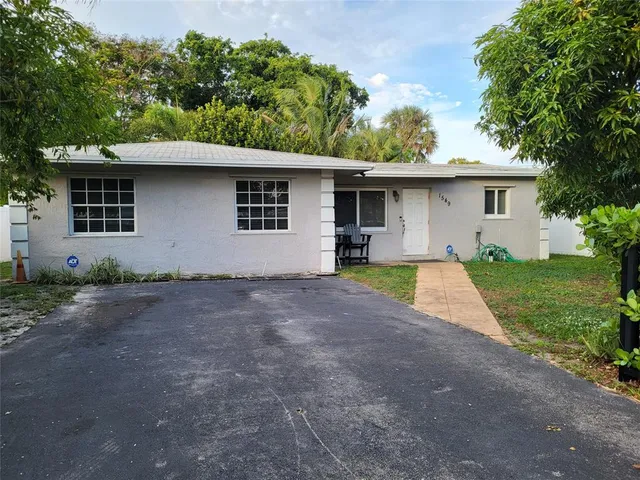 a view of a yard with a house and a tree