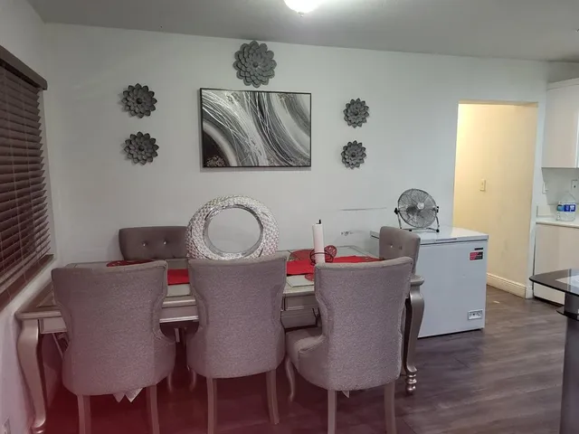 a view of a dining room with furniture and wooden floor