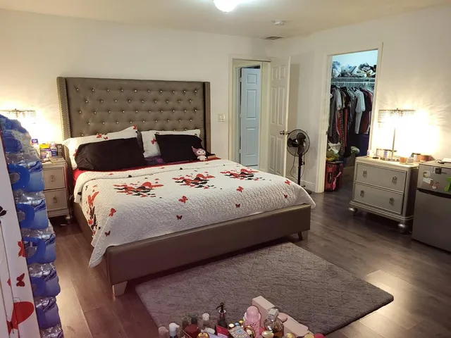 a bedroom with a bed and a dresser