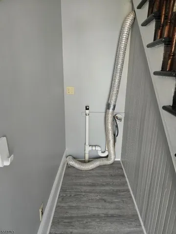 a view of a livingroom with wooden floor and stairs