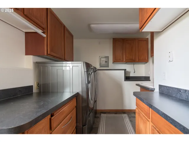 a backyard of a house with large window and wooden fence