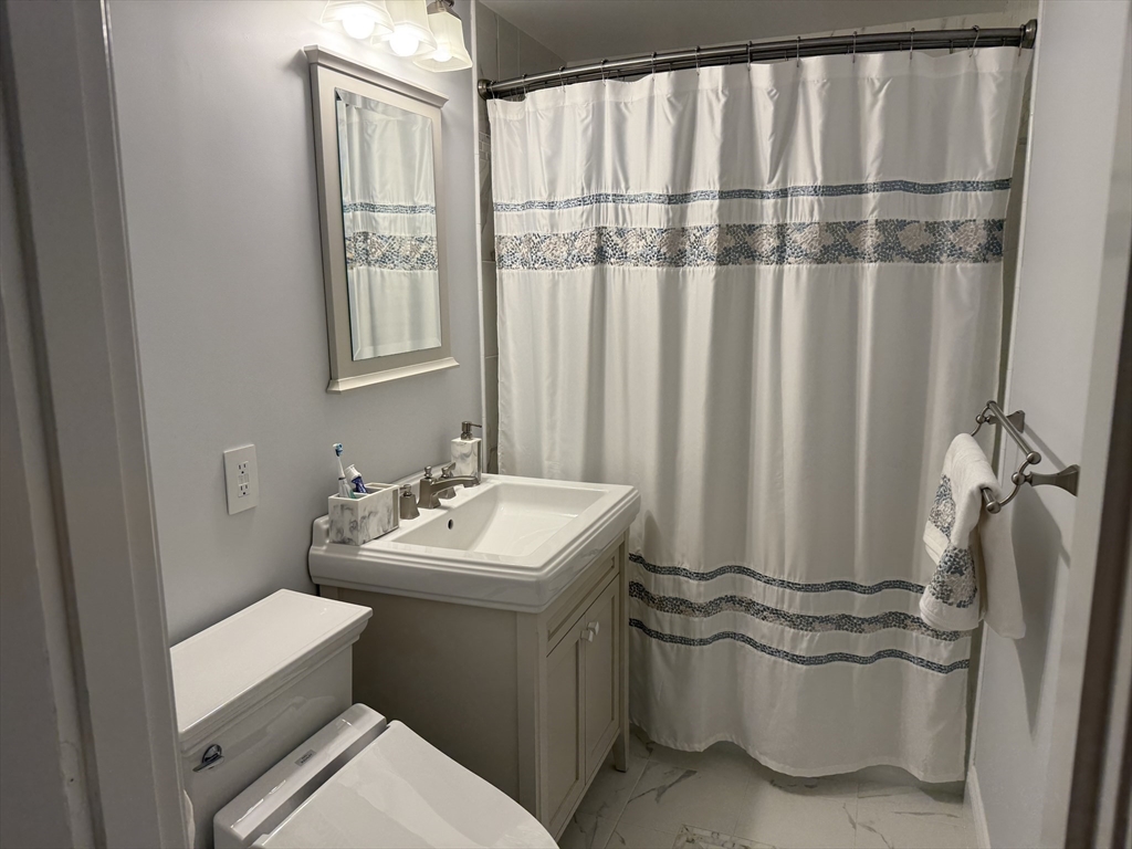 5 Porter Road, Unit 202 Andover, MA 01810 - Photo 10 of 17 a bathroom with a sink toilet and shower