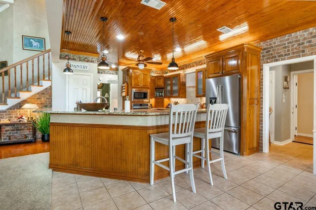 a view of a house with backyard porch and sitting area