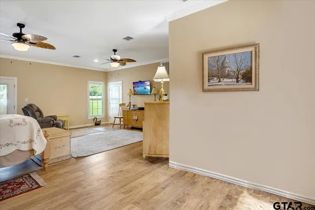 a living room with furniture and wooden floor
