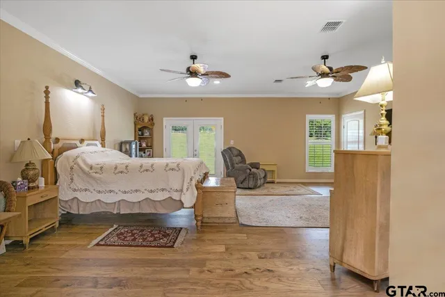 a living room with a bed furniture and kitchen view