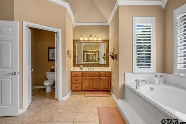 a view of a kitchen with fridge and windows