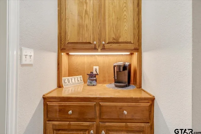 a view of a dining room with furniture a chandelier and wooden floor