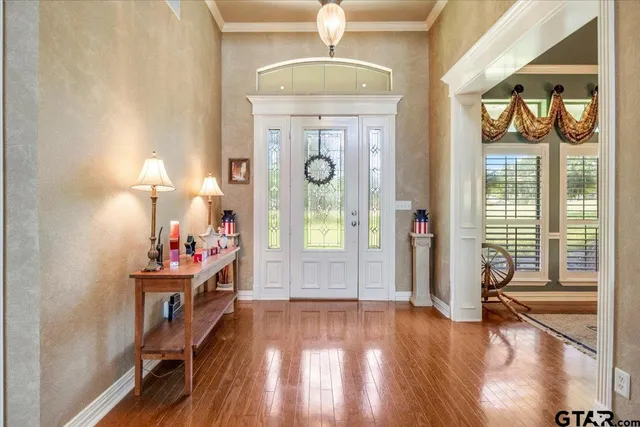 a bedroom with furniture and a large window