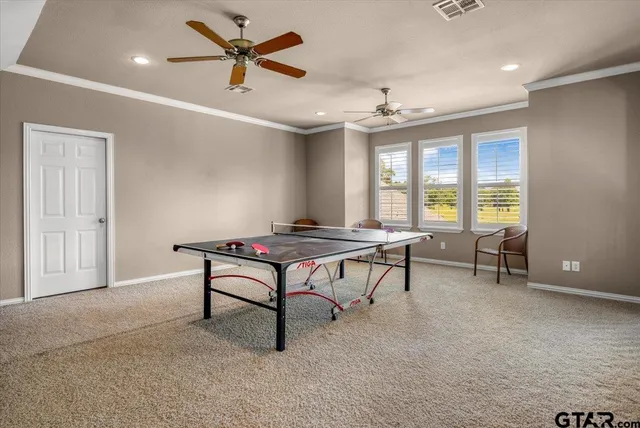 a room with furniture pool table and windows