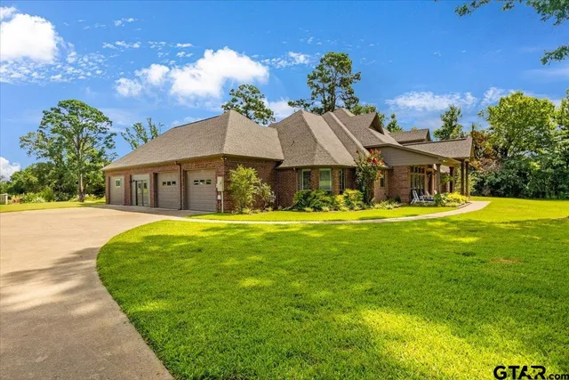 a front view of a house with swimming pool having outdoor seating