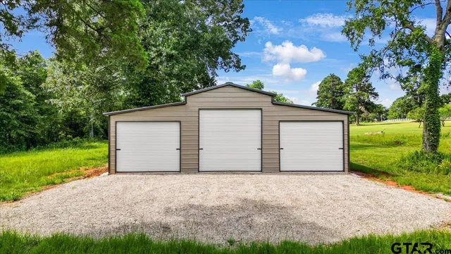 a view of a grassy field with trees around