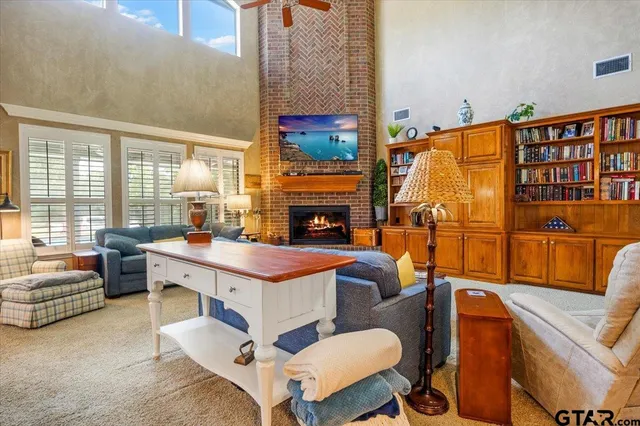 a living room with furniture a fireplace and city view