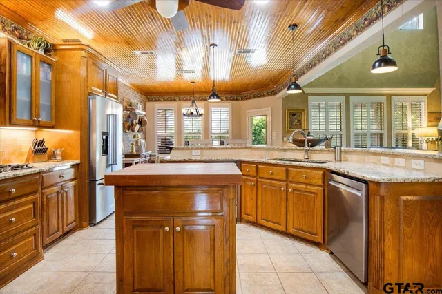 a kitchen with stainless steel appliances granite countertop a sink and cabinets