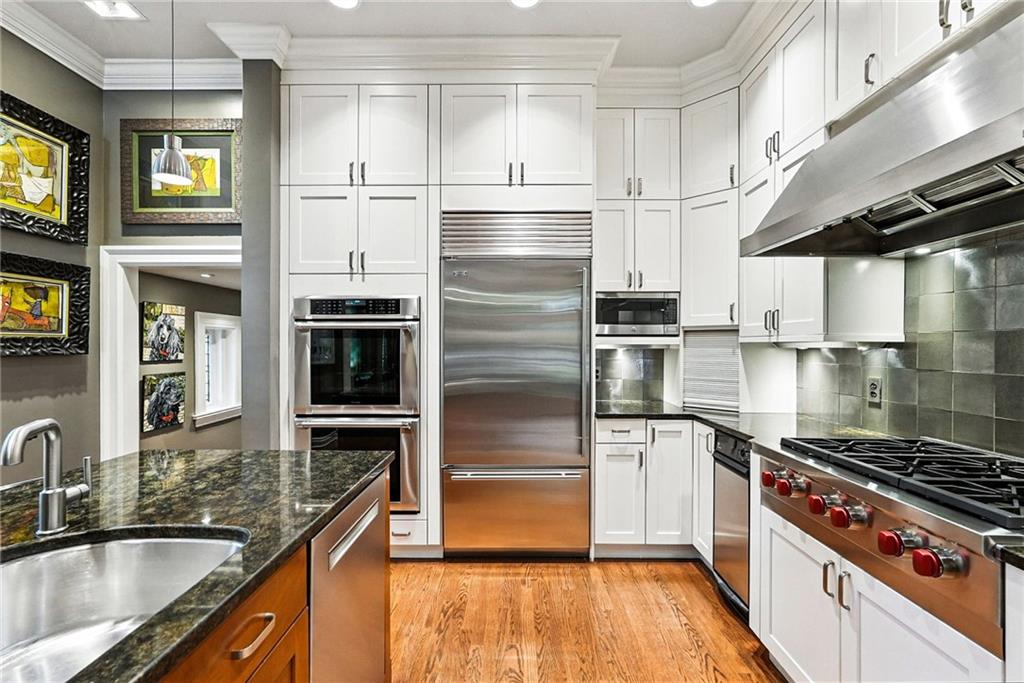 400 Devonshire Street Pittsburgh, PA 15213 - Photo 16 of 49 a kitchen with kitchen island a counter top space a sink stainless steel appliances and cabinets