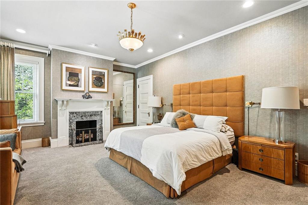 400 Devonshire Street Pittsburgh, PA 15213 - Photo 24 of 49 a bedroom with a bed and a fireplace