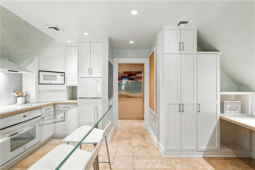 400 Devonshire Street Pittsburgh, PA 15213 - Photo 39 of 49 a kitchen with stainless steel appliances kitchen island granite countertop a refrigerator and a sink
