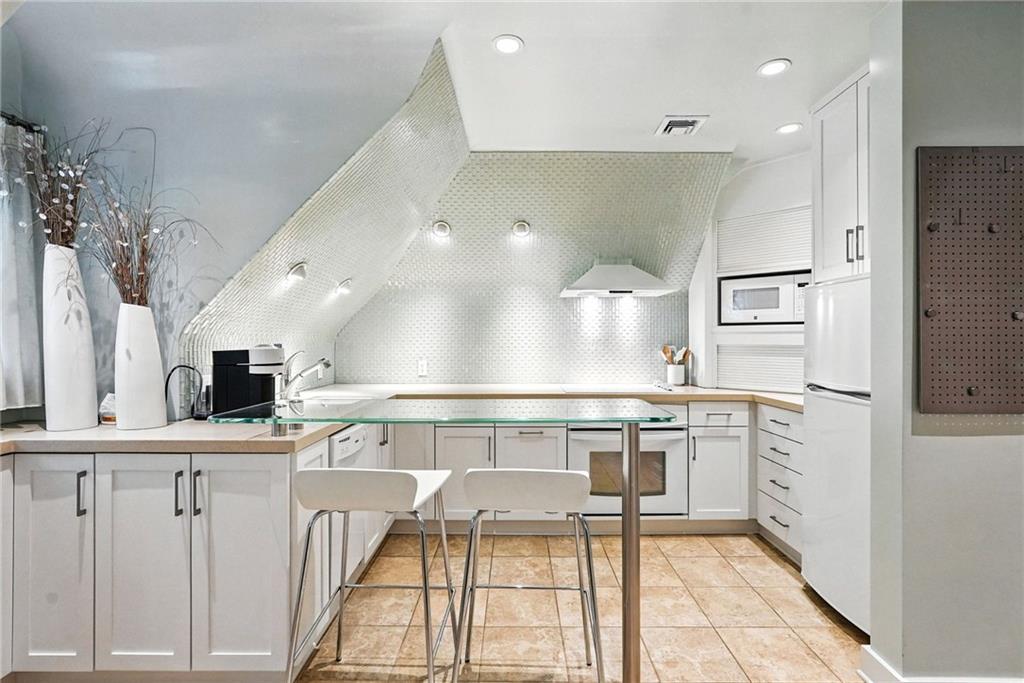 400 Devonshire Street Pittsburgh, PA 15213 - Photo 41 of 49 a kitchen with stainless steel appliances granite countertop a sink and a refrigerator