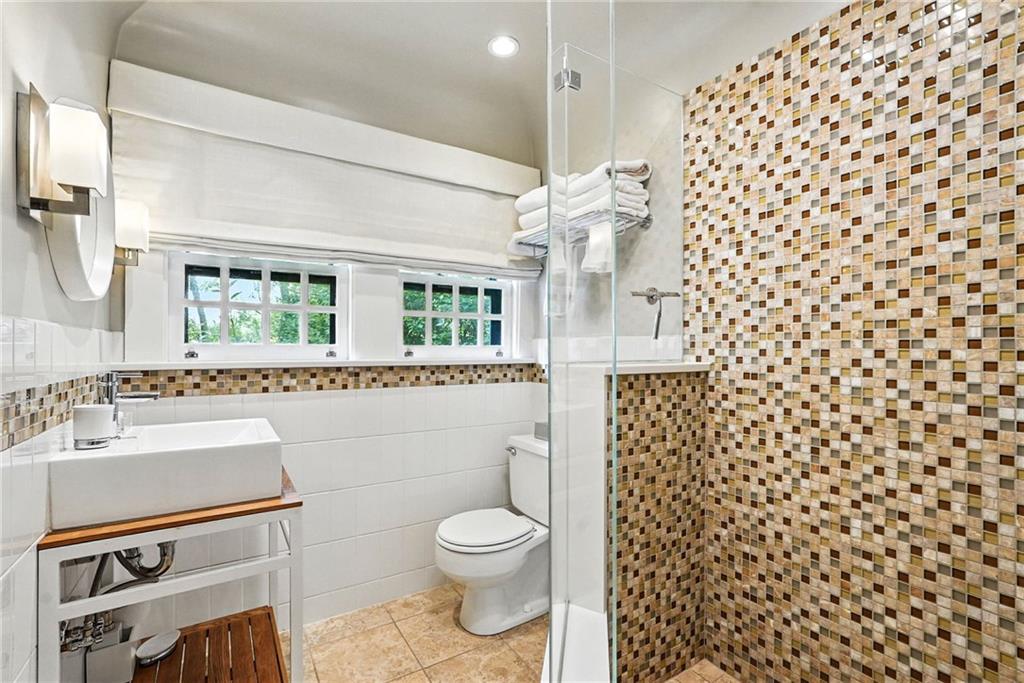 400 Devonshire Street Pittsburgh, PA 15213 - Photo 42 of 49 a bathroom with a sink toilet a mirror and shower