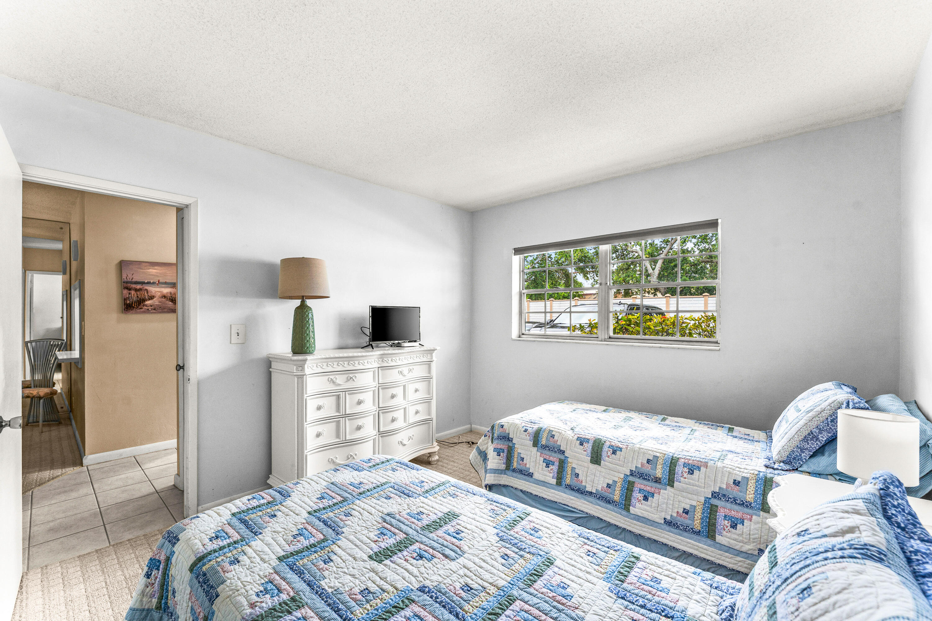 1951 Northeast 39th Street, Unit 131 Lighthouse Point, FL 33064 - Photo 14 of 31 a bedroom with a bed and wooden floor