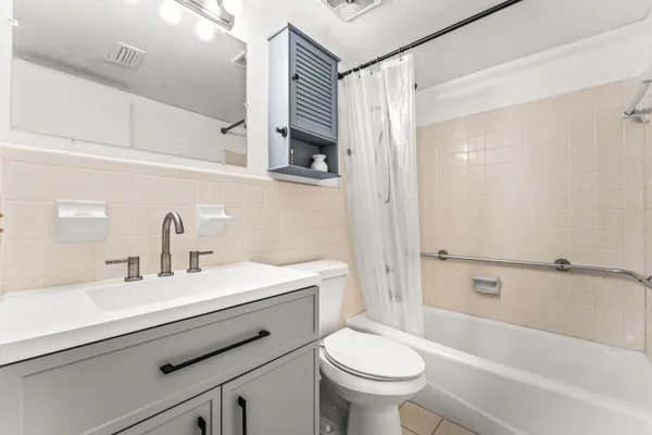 a view of a dining room and livingroom furniture wooden floor a chandelier and a rug