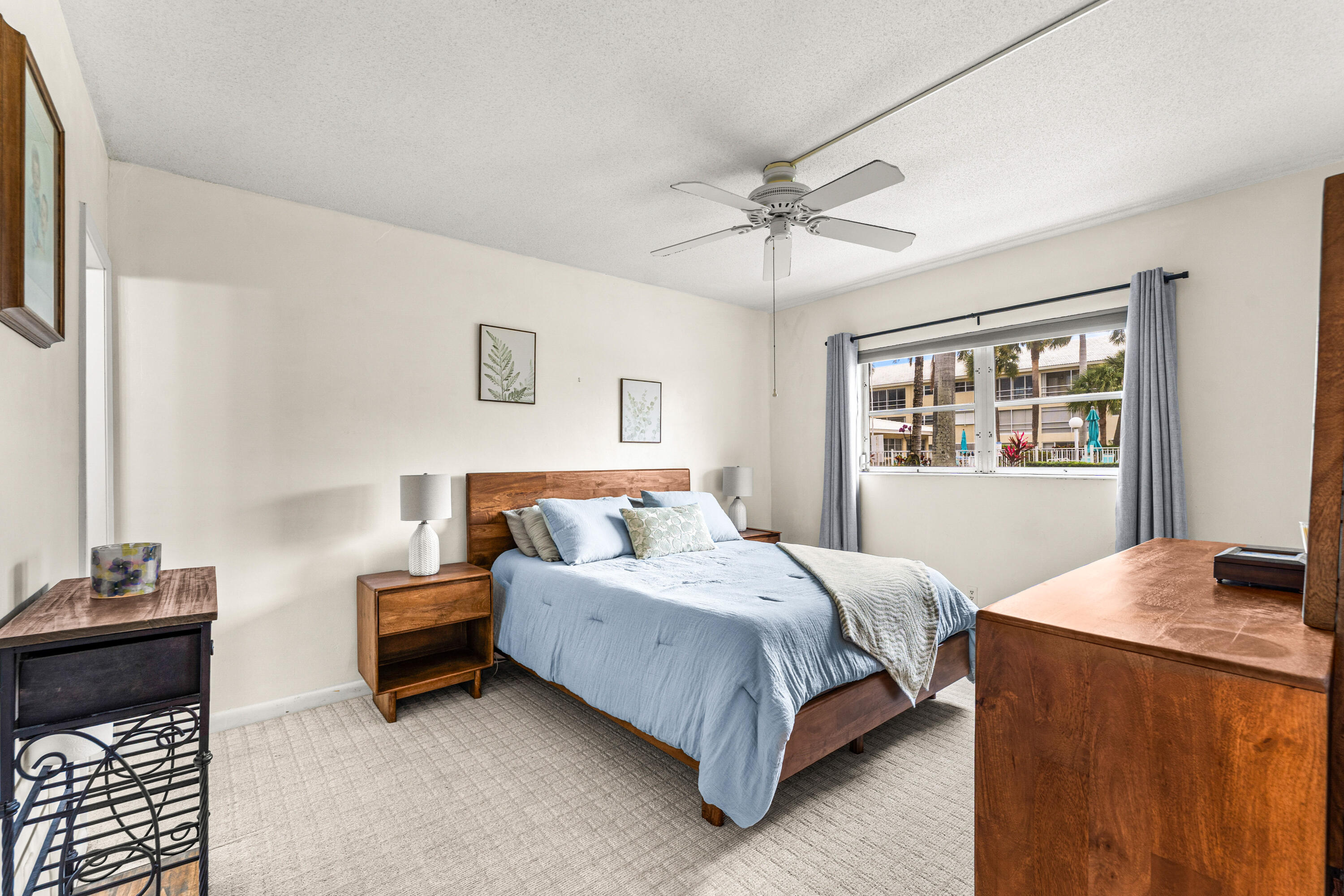 1951 Northeast 39th Street, Unit 131 Lighthouse Point, FL 33064 - Photo 20 of 31 a bedroom with a bed and a window