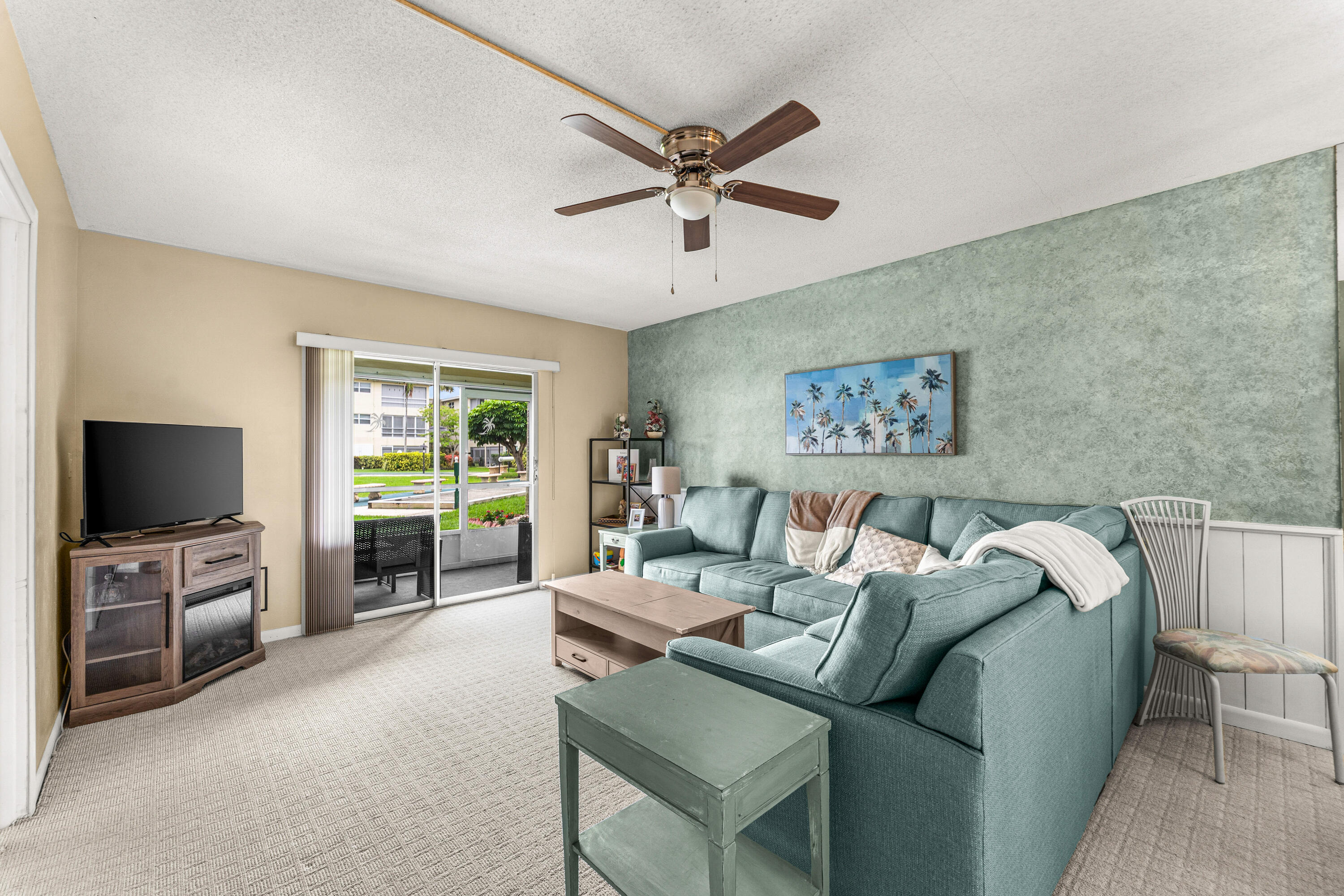 1951 Northeast 39th Street, Unit 131 Lighthouse Point, FL 33064 - Photo 23 of 31 a living room with furniture and a flat screen tv