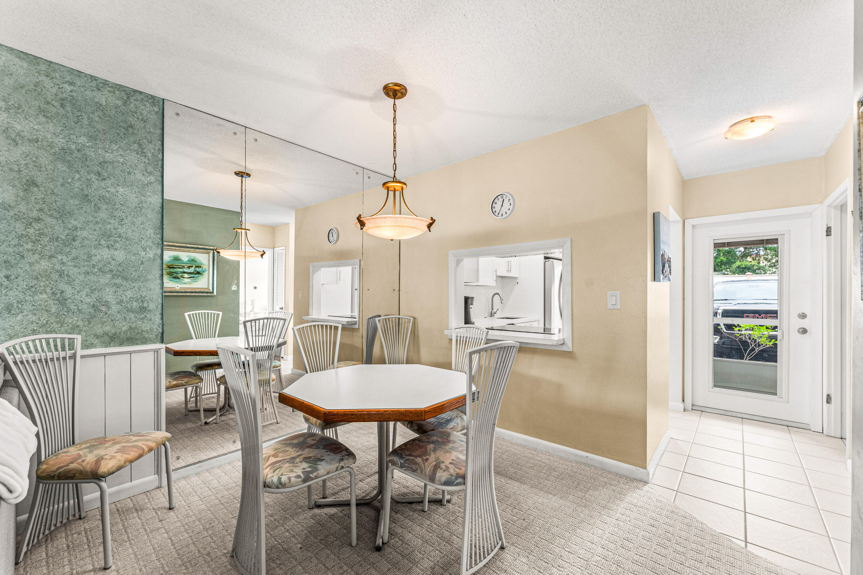 1951 Northeast 39th Street, Unit 131 Lighthouse Point, FL 33064 - Photo 24 of 31 a view of a dining room and livingroom furniture wooden floor a chandelier and a rug