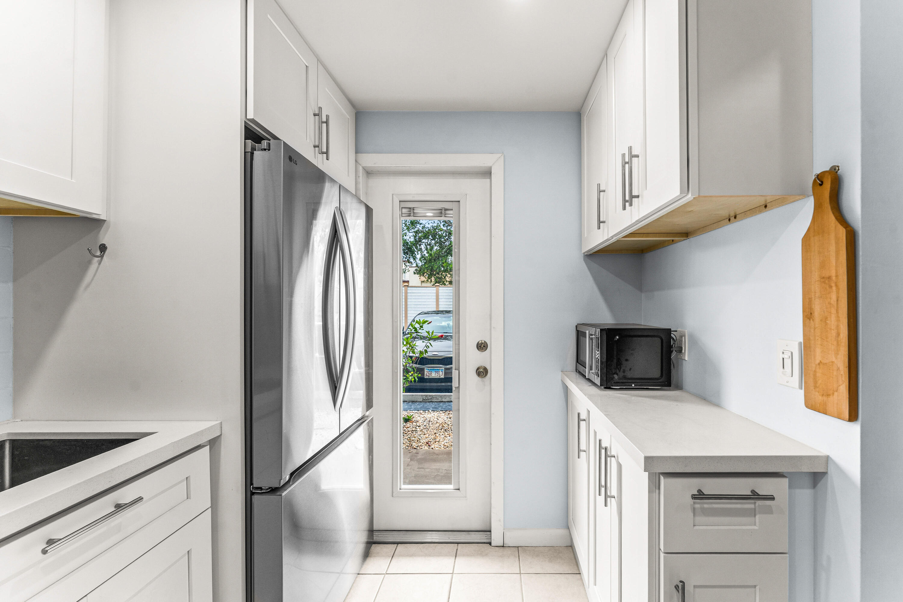 1951 Northeast 39th Street, Unit 131 Lighthouse Point, FL 33064 - Photo 26 of 31 a kitchen with stainless steel appliances a refrigerator and a stove