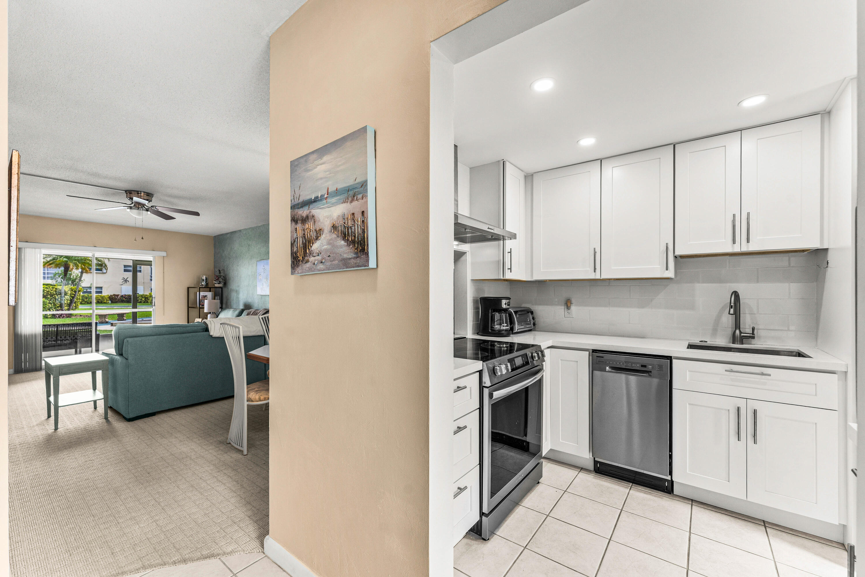 1951 Northeast 39th Street, Unit 131 Lighthouse Point, FL 33064 - Photo 28 of 31 a kitchen with cabinets and stainless steel appliances