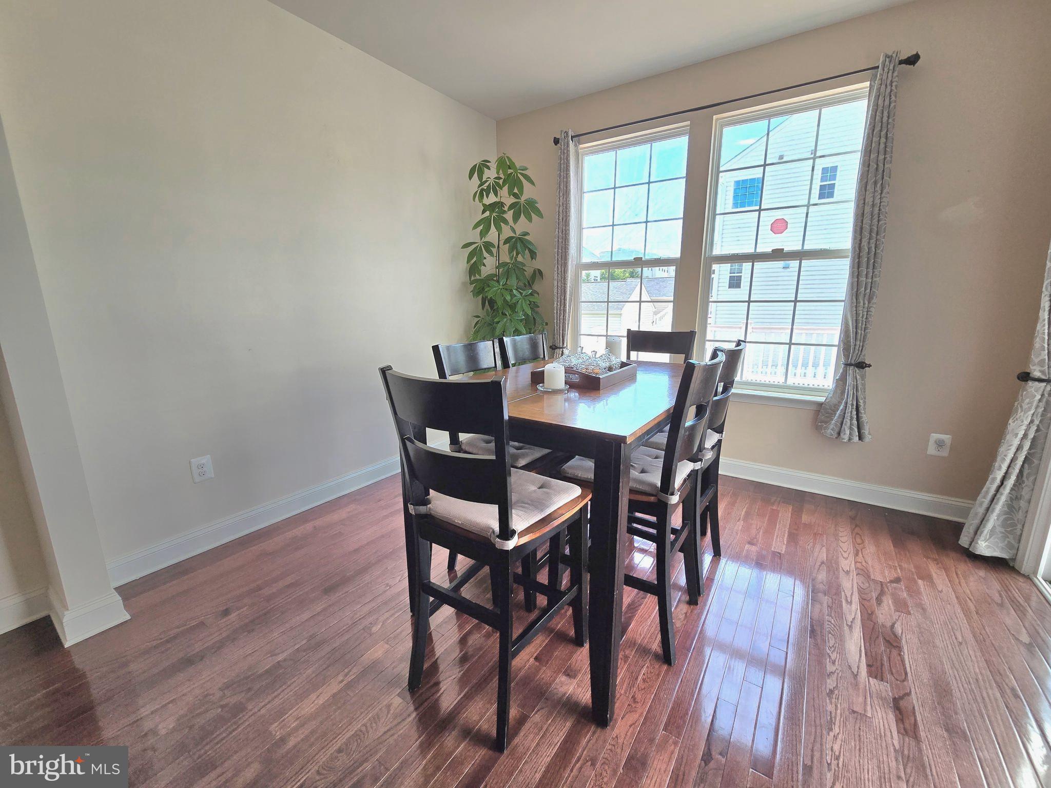 23012 Meadow Mist Road Clarksburg, MD 20871 - Photo 7 of 19 a view of a dining room with furniture and wooden floor