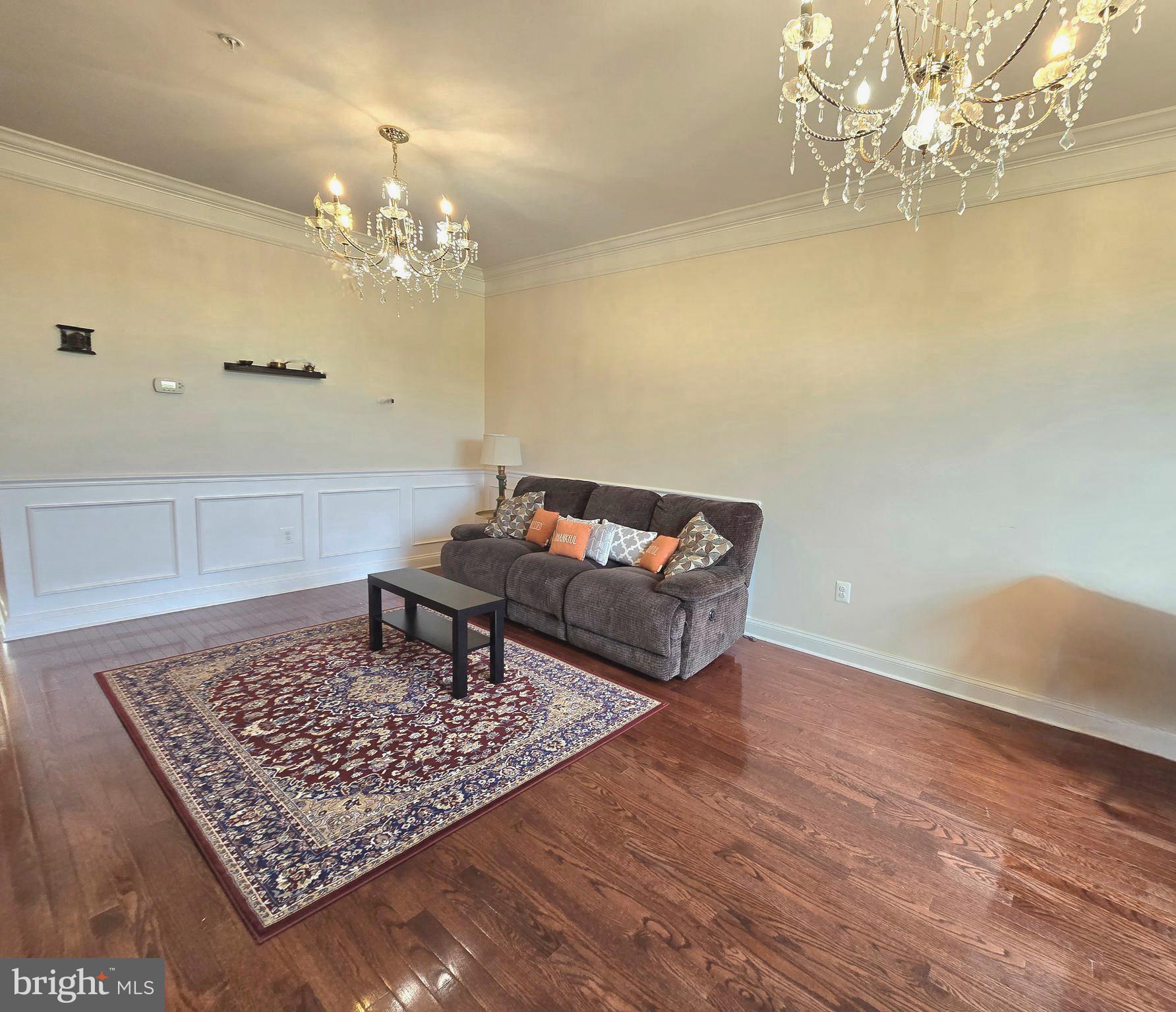 23012 Meadow Mist Road Clarksburg, MD 20871 - Photo 10 of 19 a living room with a couch and chandelier