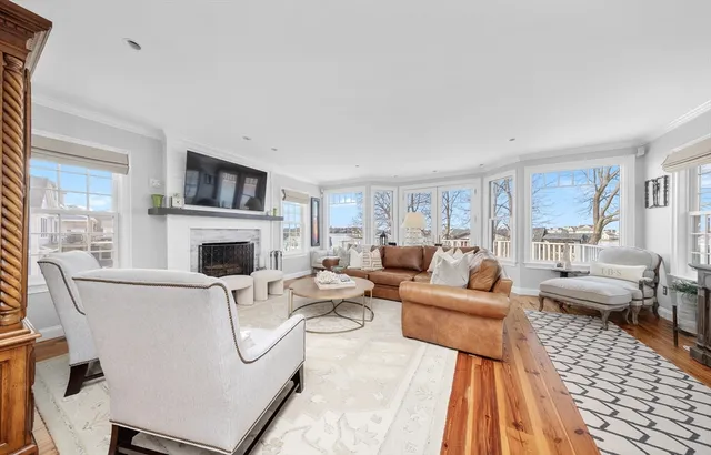 a living room with furniture a fireplace and a flat screen tv