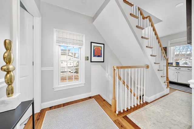 a view of a hallway with windows and stairs