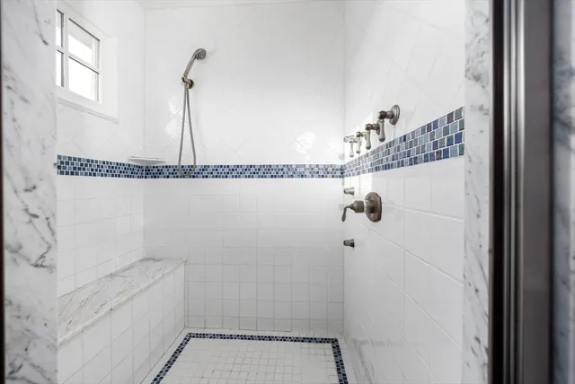 a spacious bedroom with a bed and ceiling fan