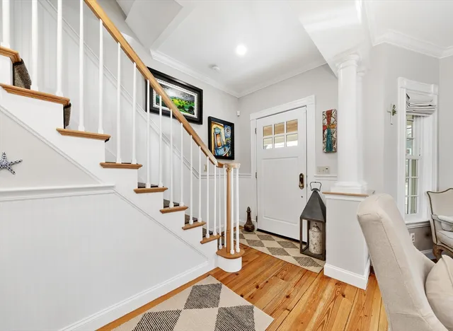 a view of an entryway with wooden floor and windows