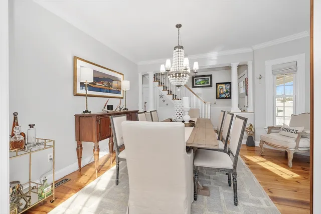 a view of a dining room with furniture wooden floor and chandelier