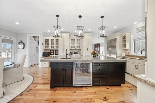a spacious bathroom with a granite countertop sink a mirror and shower