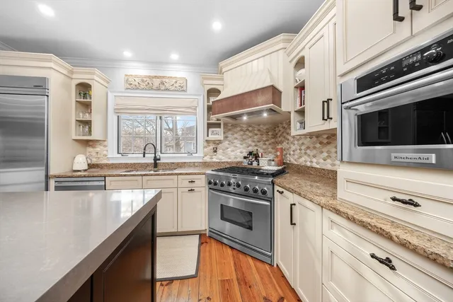 a kitchen with stainless steel appliances granite countertop a stove and a microwave